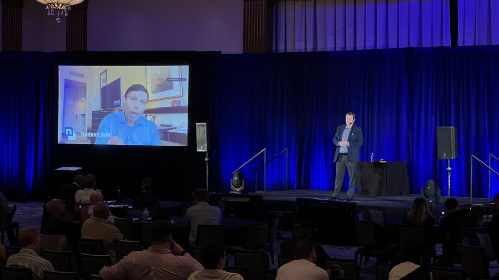 Remote presenter displayed on screen at Scottsdale corporate event